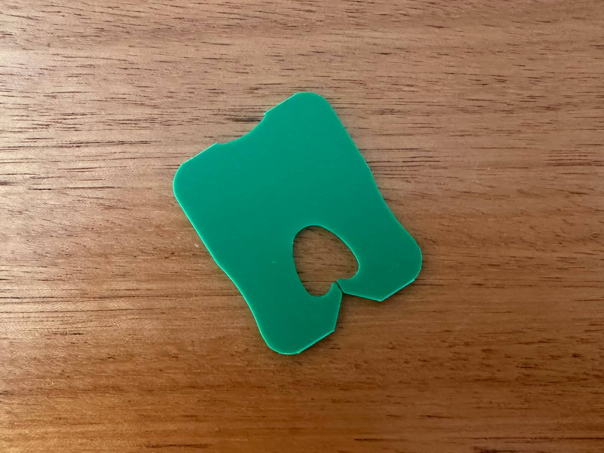 Green bread tag lying on a wooden background