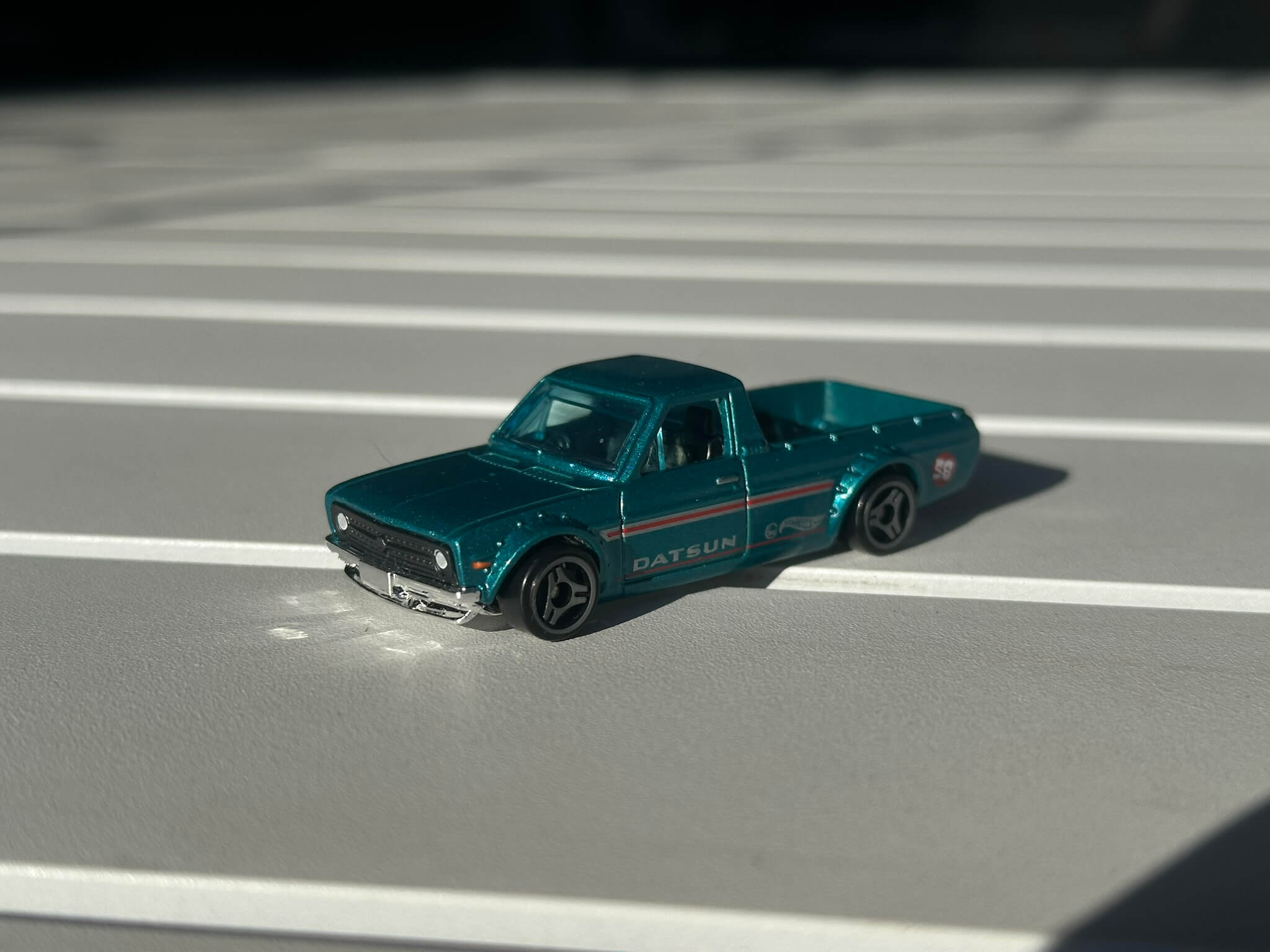 Close up of teal toy car on white table