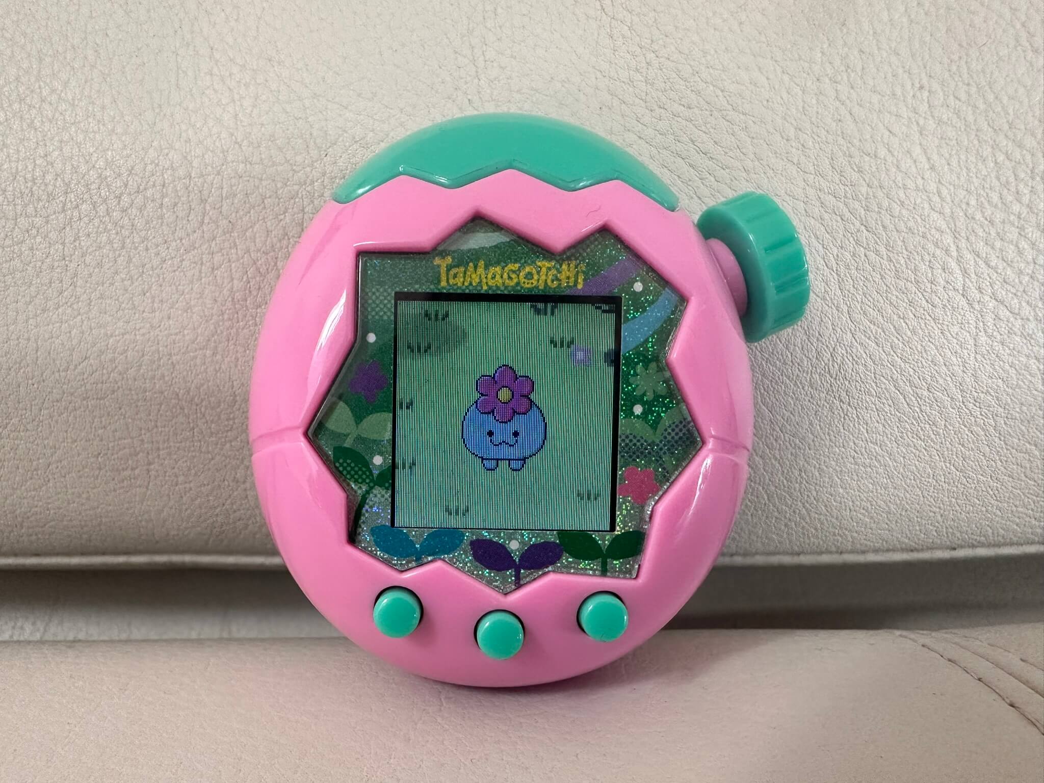Pink Tamagotchi on a white lounge